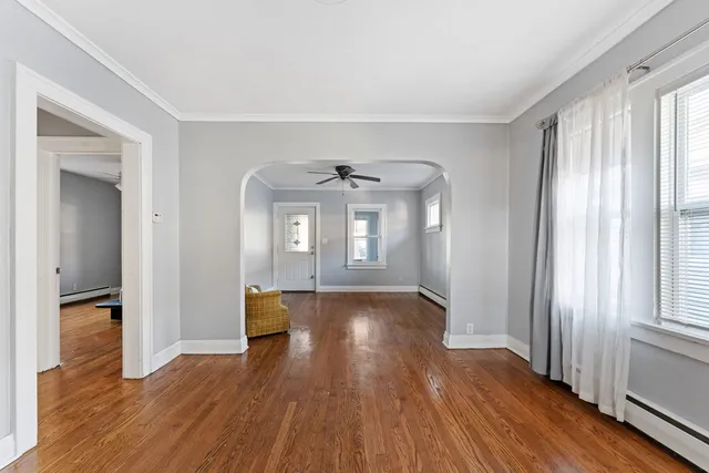 wooden floor in an empty room with a window