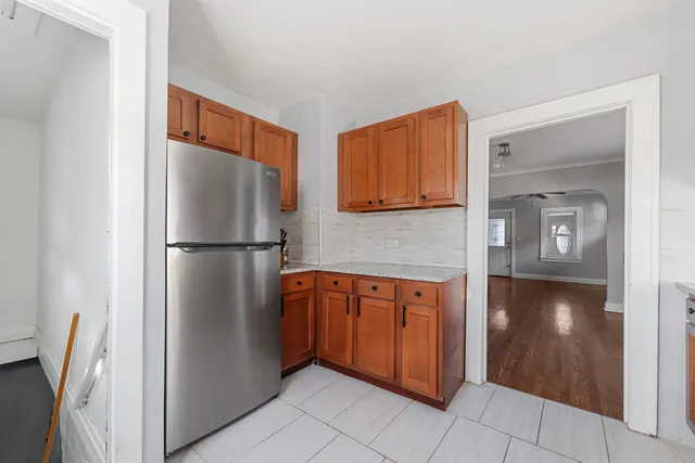 a kitchen with stainless steel appliances granite countertop a refrigerator and a sink