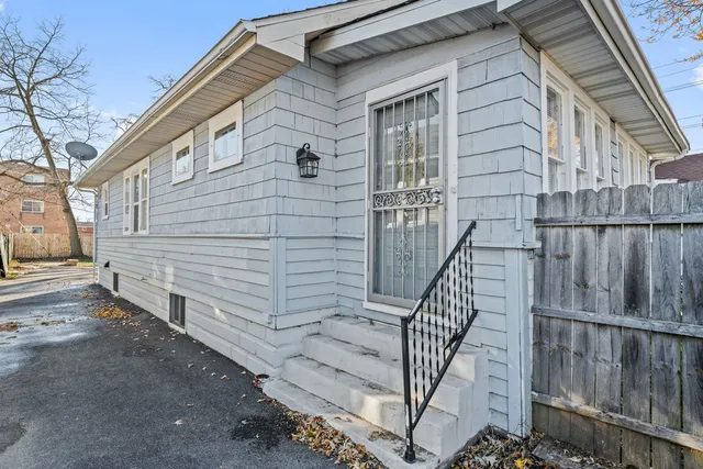 a view of a house with wooden fence