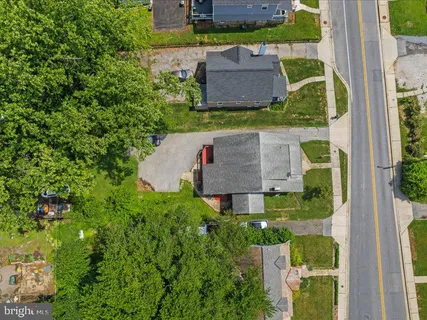 an aerial view of a houses with yard