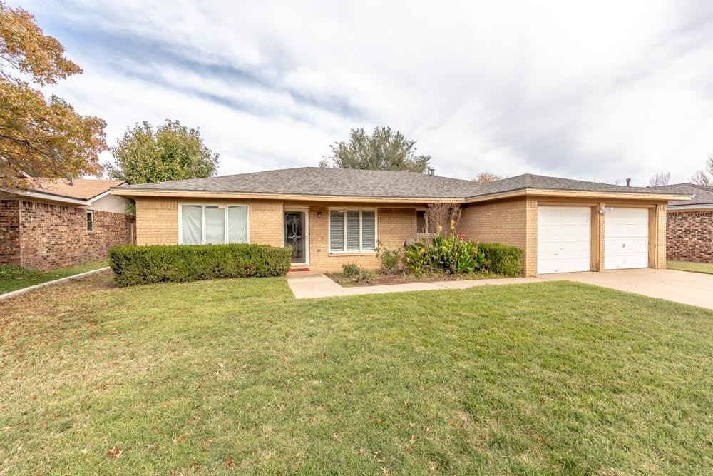 5402 94th Street Lubbock, TX 79424 - Photo 1 of 24 a view of a house with a patio and a yard