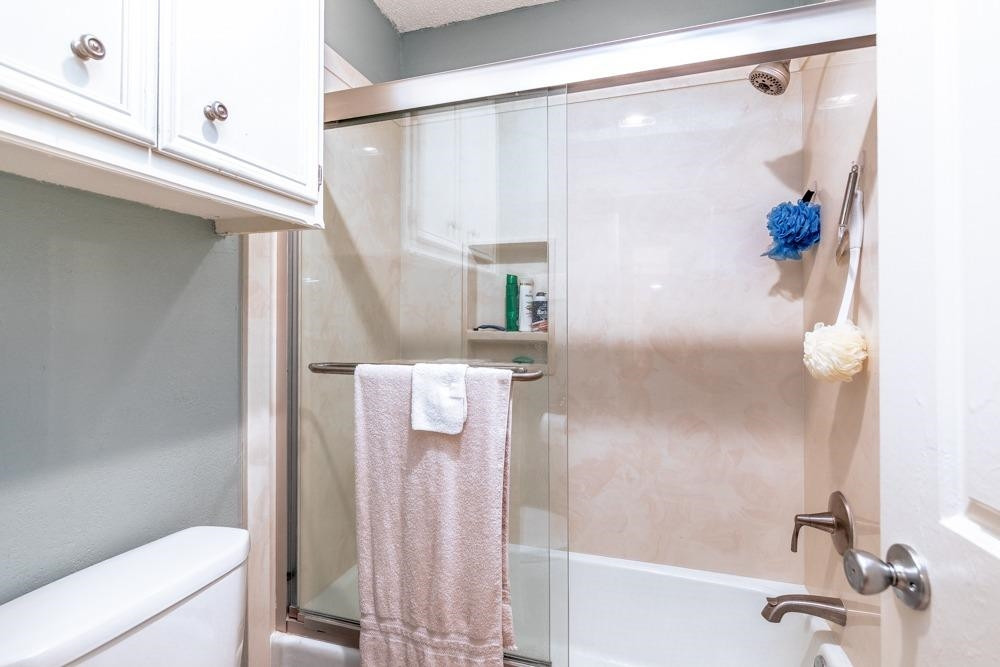 5402 94th Street Lubbock, TX 79424 - Photo 13 of 24 a bathroom with a shower and a toilet