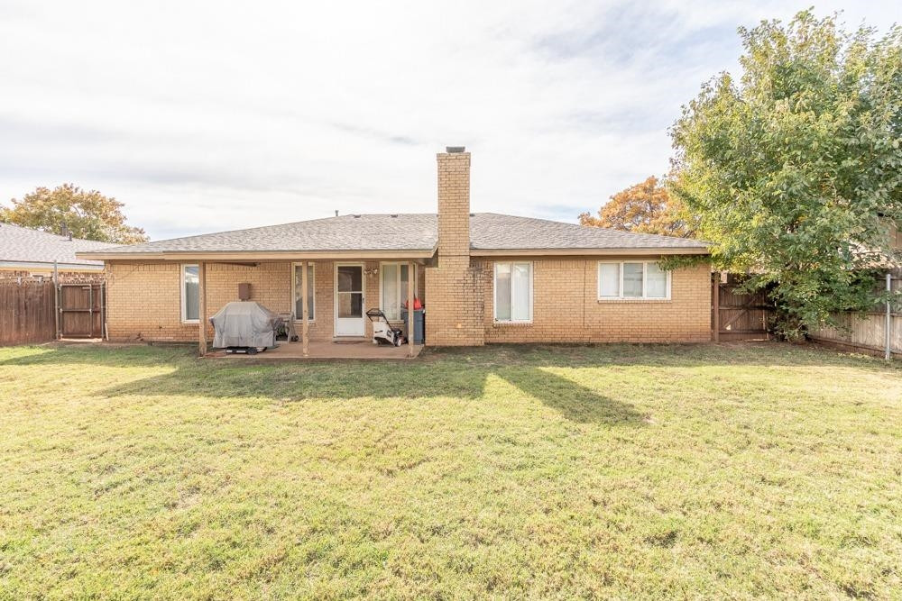 5402 94th Street Lubbock, TX 79424 - Photo 18 of 24 a view of a house with swimming pool and a yard