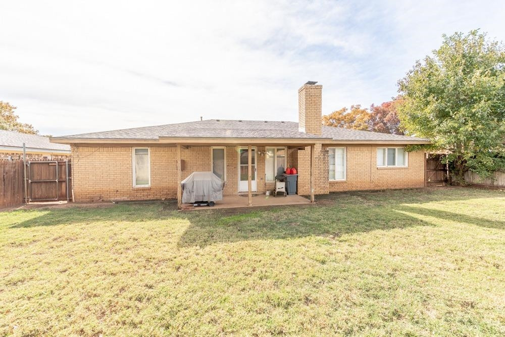 5402 94th Street Lubbock, TX 79424 - Photo 19 of 24 a front view of a house with a garden and yard