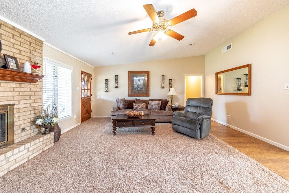 5402 94th Street Lubbock, TX 79424 - Photo 2 of 24 a living room with furniture and a fireplace