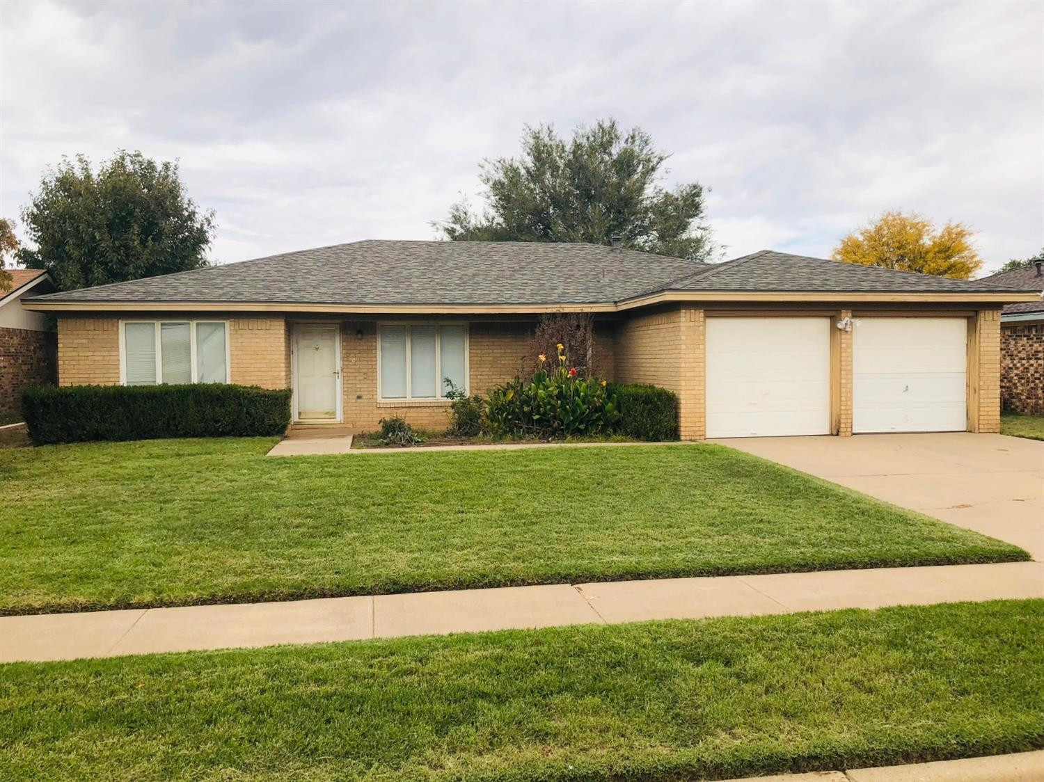 5402 94th Street Lubbock, TX 79424 - Photo 21 of 24 a front view of a house with a garden and plants