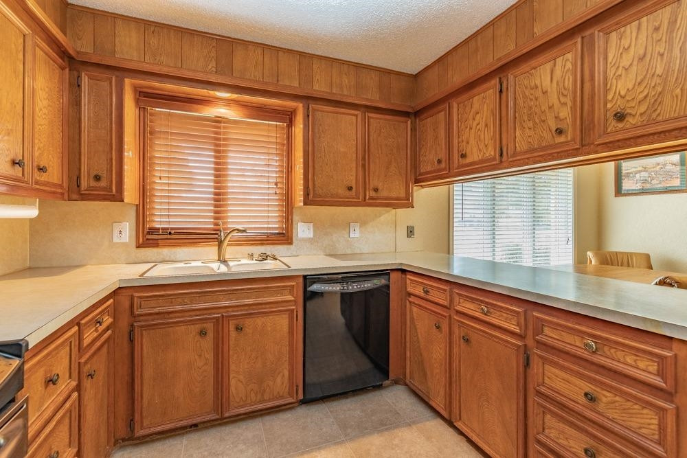 5402 94th Street Lubbock, TX 79424 - Photo 3 of 24 a kitchen with stainless steel appliances granite countertop a sink and cabinets