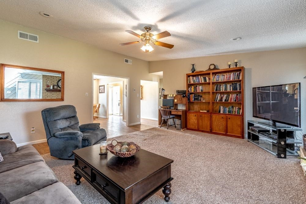 5402 94th Street Lubbock, TX 79424 - Photo 4 of 24 a living room with furniture and a flat screen tv