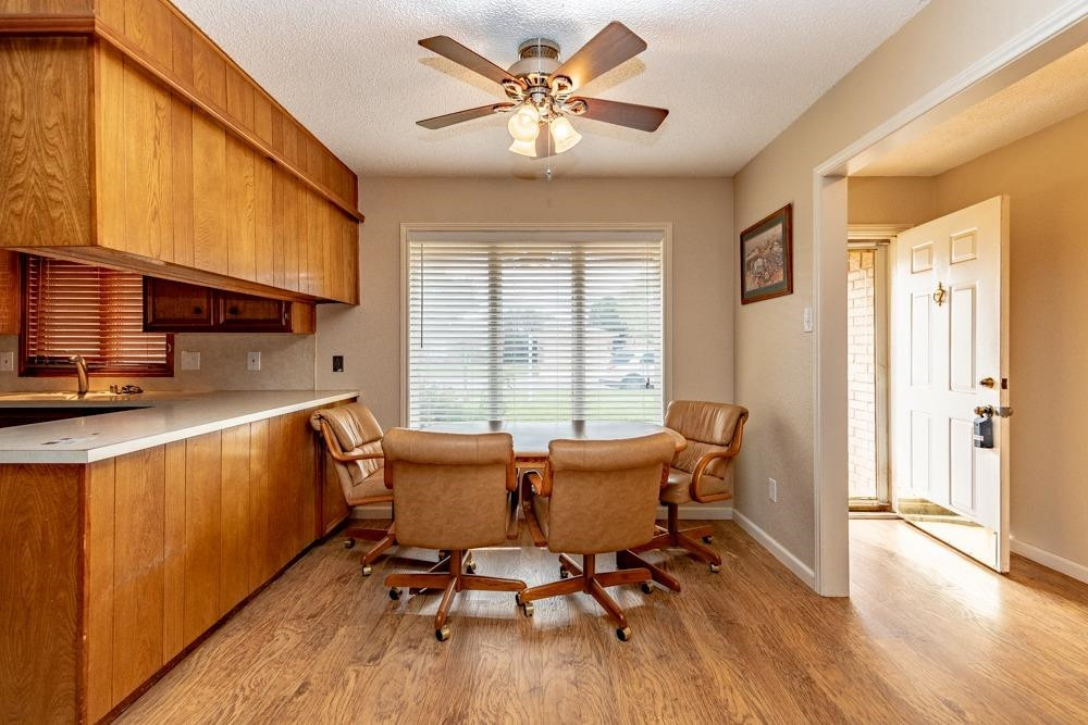 5402 94th Street Lubbock, TX 79424 - Photo 7 of 24 a view of a dining room with furniture window and wooden floor