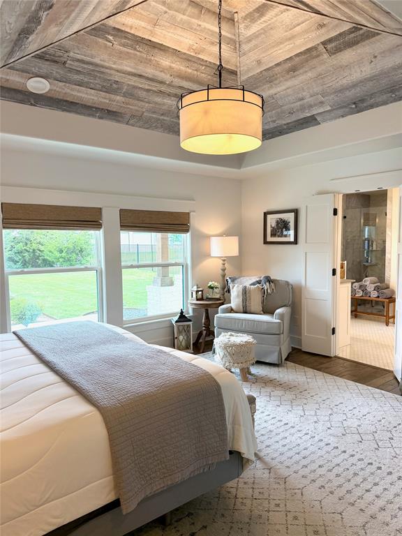1304 Tinker Road Colleyville, TX 76034 - Photo 10 of 28 a bedroom with a bed and a chandelier