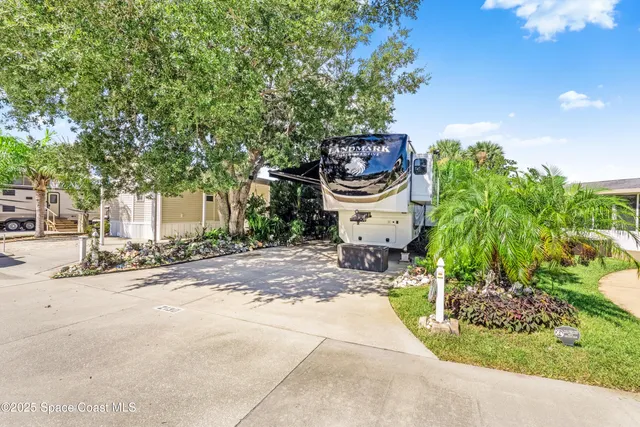 a view of a house with garden and street