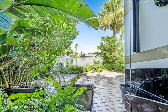 a backyard of a house with lots of green space and lake view