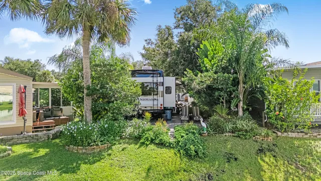 aerial view of a house with a yard and potted plants