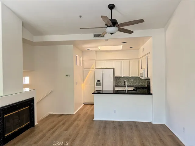 a view of a kitchen with a sink stainless steel appliances and cabinets