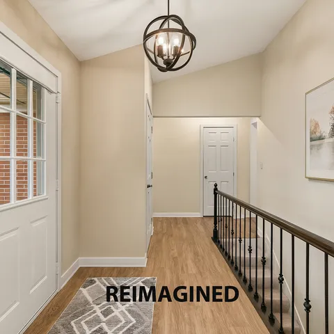 a view of a livingroom with wooden floor and entryway