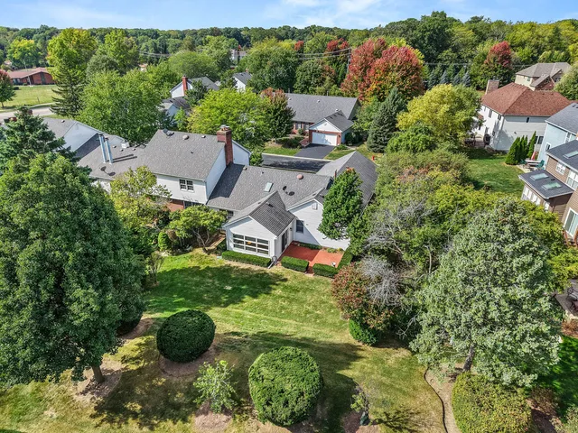 an aerial view of a house with yard and outdoor seating