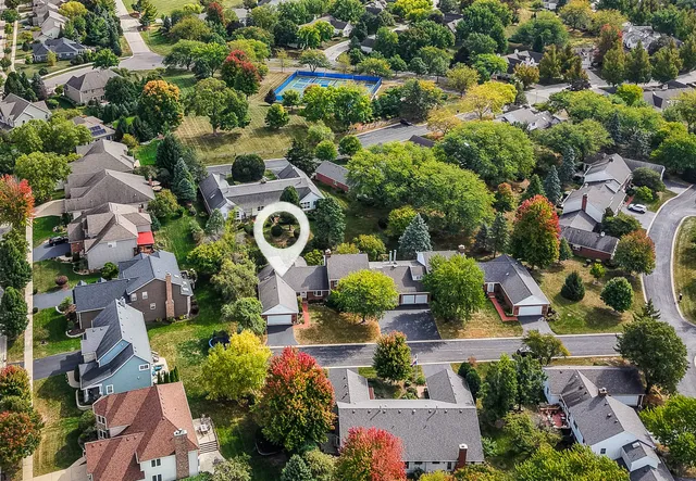 an aerial view of residential house with outdoor space and swimming pool