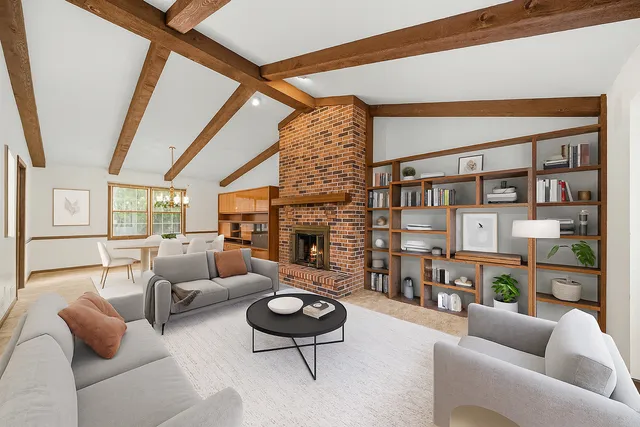a living room with fireplace furniture and a floor to ceiling window