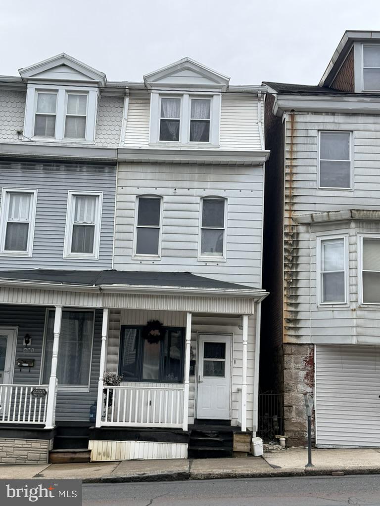 a view of a brick house with large windows