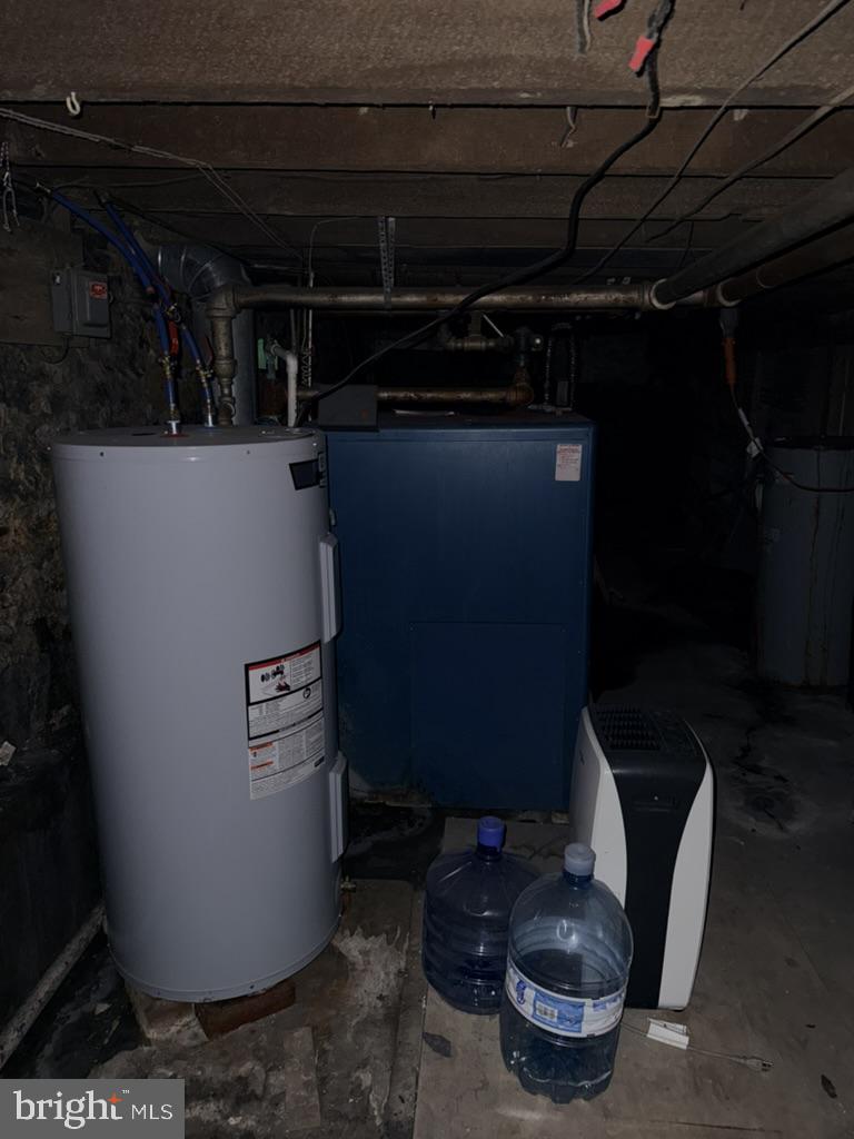 1222 Centre Street Ashland, PA 17921 - Photo 14 of 31 a room with water heater and wooden cabinets