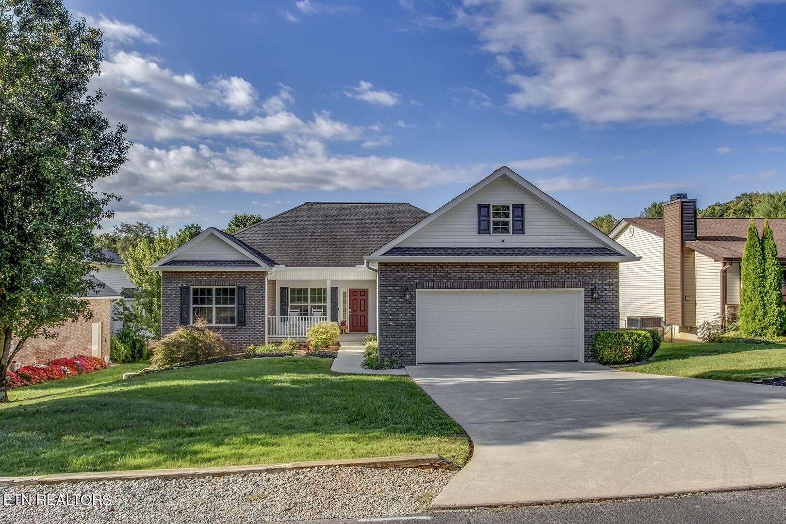 134 Daleyuhski Way Loudon, TN 37774 - Photo 1 of 54 a front view of a house with a garden and plants