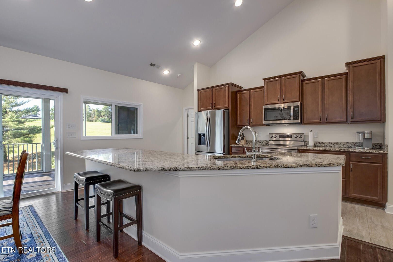134 Daleyuhski Way Loudon, TN 37774 - Photo 20 of 54 a kitchen with granite countertop a table chairs microwave and cabinets