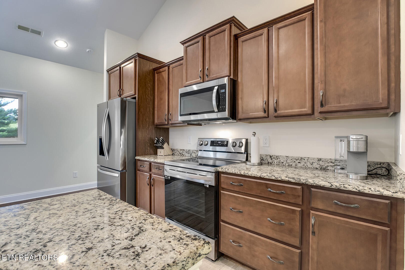 134 Daleyuhski Way Loudon, TN 37774 - Photo 25 of 54 a kitchen with stainless steel appliances granite countertop a stove a sink dishwasher a refrigerator and cabinets with wooden floor