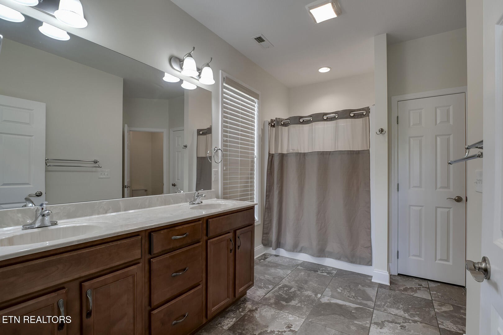 134 Daleyuhski Way Loudon, TN 37774 - Photo 29 of 54 a bathroom with a double vanity sink and a mirror