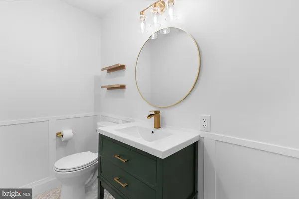 a bathroom with a sink mirror and toilet