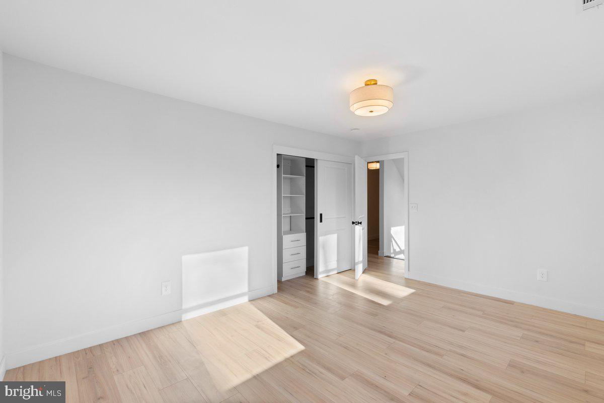 144 Van Dyke Road Hopewell, NJ 08525 - Photo 21 of 59 a view of an empty room with wooden floor and a window