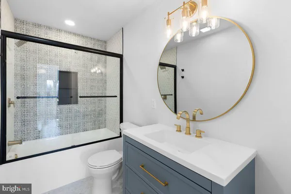 a bathroom with a sink a toilet and mirror