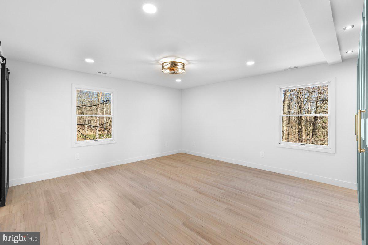 144 Van Dyke Road Hopewell, NJ 08525 - Photo 26 of 59 an empty room with wooden floor and windows