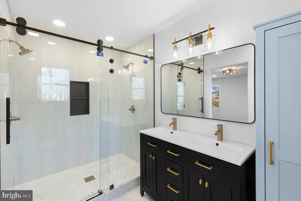 a bathroom with a double vanity sink and mirror