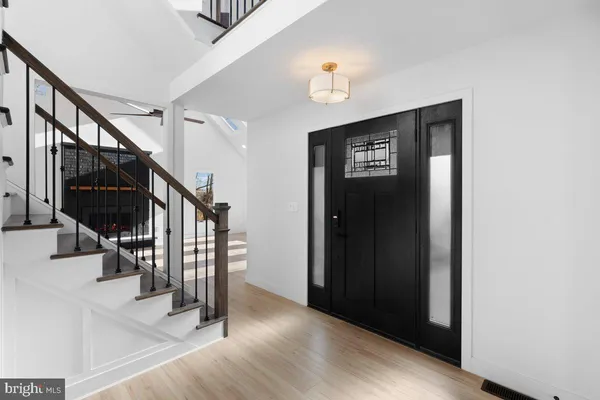 a view of entryway with stairs and wooden floor