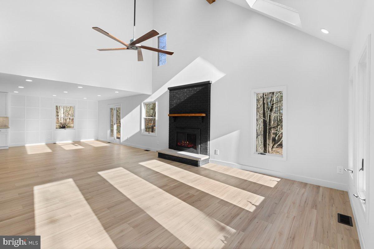 144 Van Dyke Road Hopewell, NJ 08525 - Photo 6 of 59 a view of a hallway with wooden floor and a ceiling fan