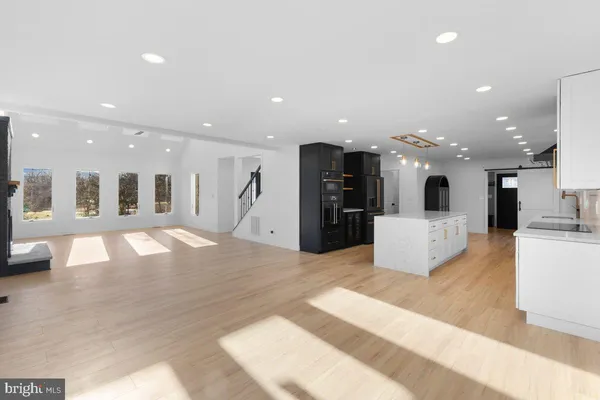 a kitchen with stainless steel appliances granite countertop a sink and a stove