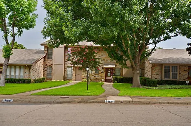a view of a park with large trees