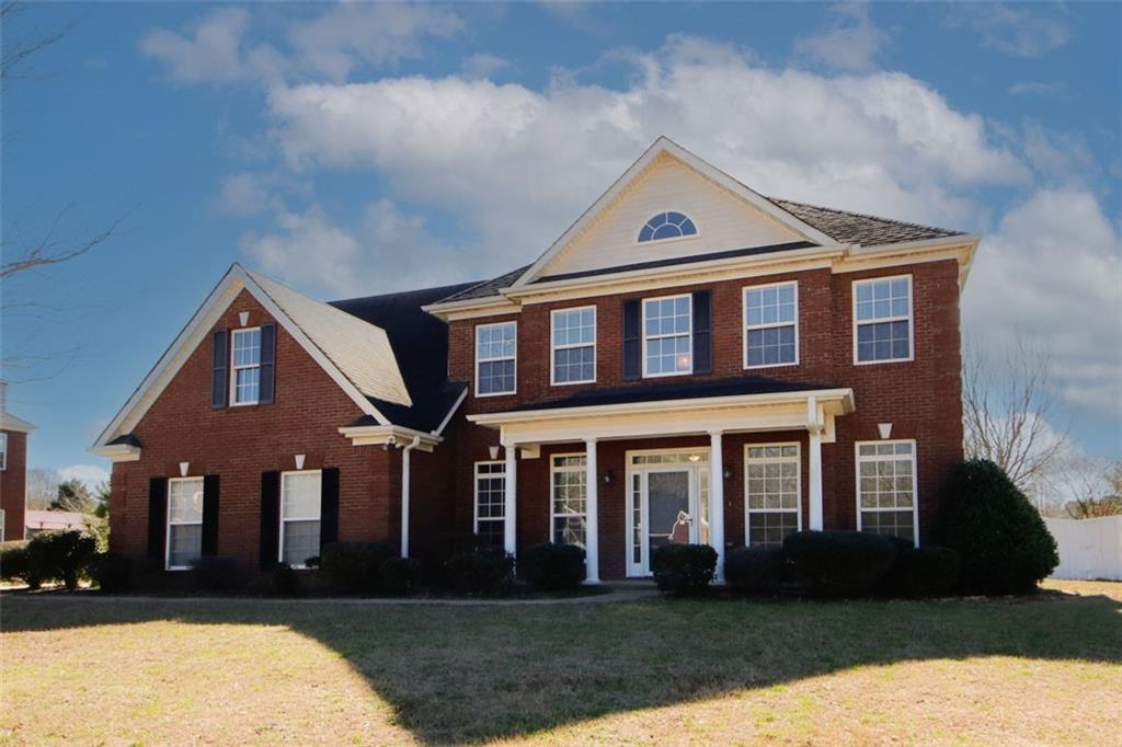 a front view of a house with a yard