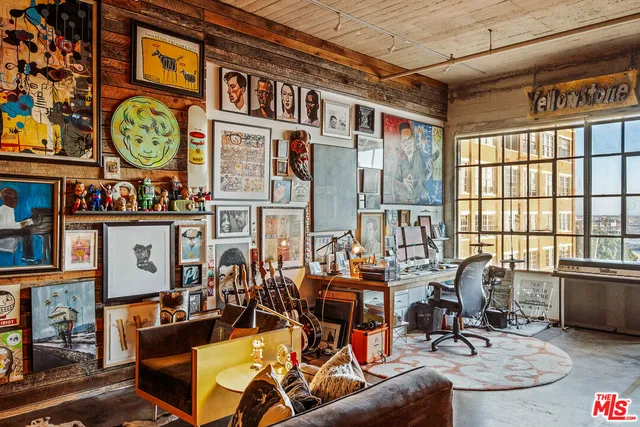 a view of a livingroom with furniture and floor to ceiling window
