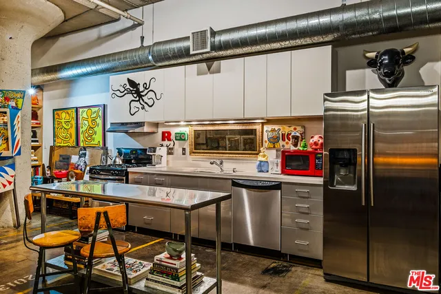 a kitchen with stainless steel appliances granite countertop a sink and cabinets
