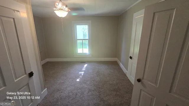 an empty room with windows and wooden floor