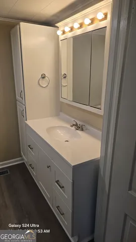 a bathroom with a granite countertop sink a toilet and a mirror