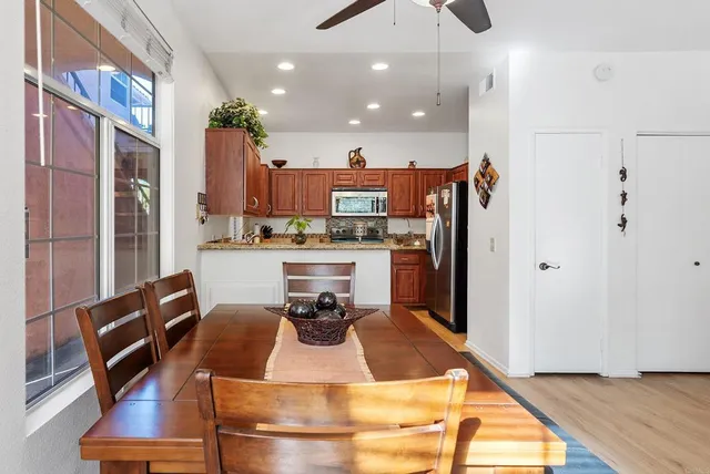 a kitchen with granite countertop wooden cabinets a sink and dishwasher