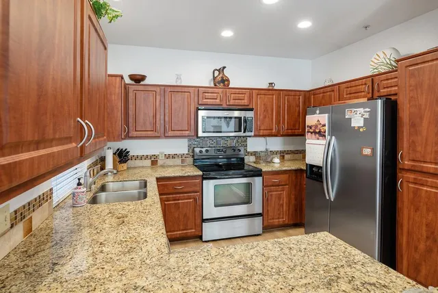 a living room with fireplace furniture and a large window