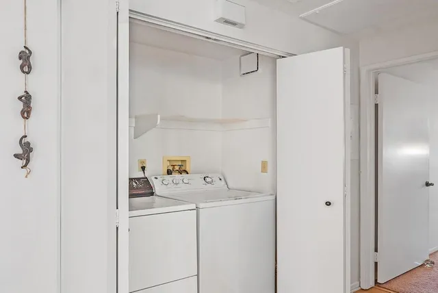 a bedroom with a large bed and a dresser next to a window