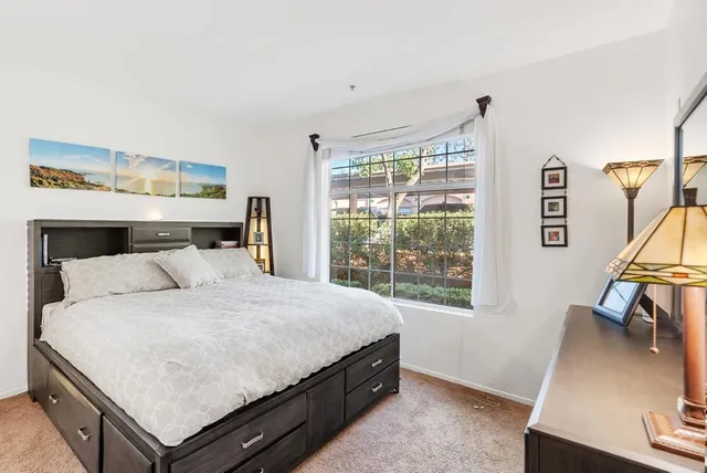 a bathroom with a granite countertop sink a mirror and shower
