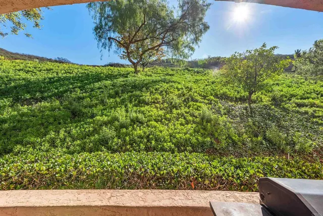 a view of a patio with table and chairs under an umbrella