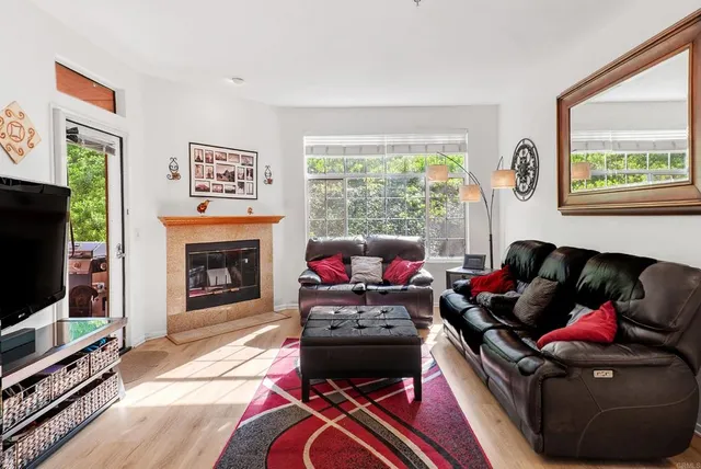 a kitchen with stainless steel appliances granite countertop a table chairs and a refrigerator
