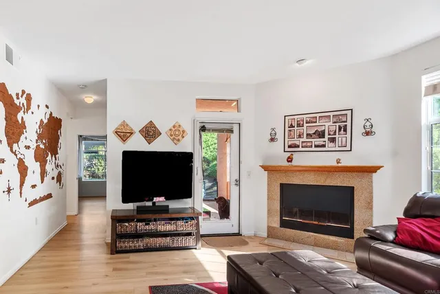 a living room with furniture a fireplace and a flat screen tv