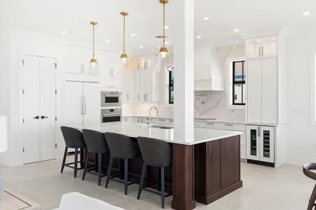 a large kitchen with lots of counter space and chairs